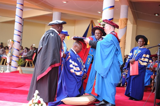 Chancellor awarding doctorate to one of the students as his supervisors watch.