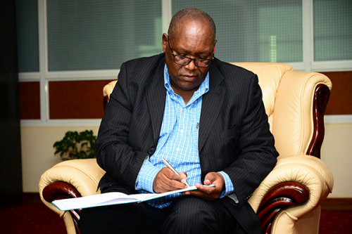 Nation-Media-Group-CEO-Mr.-Stephen-Gitagama-signing-visitors-book-at-Vice-Chancellors-Office